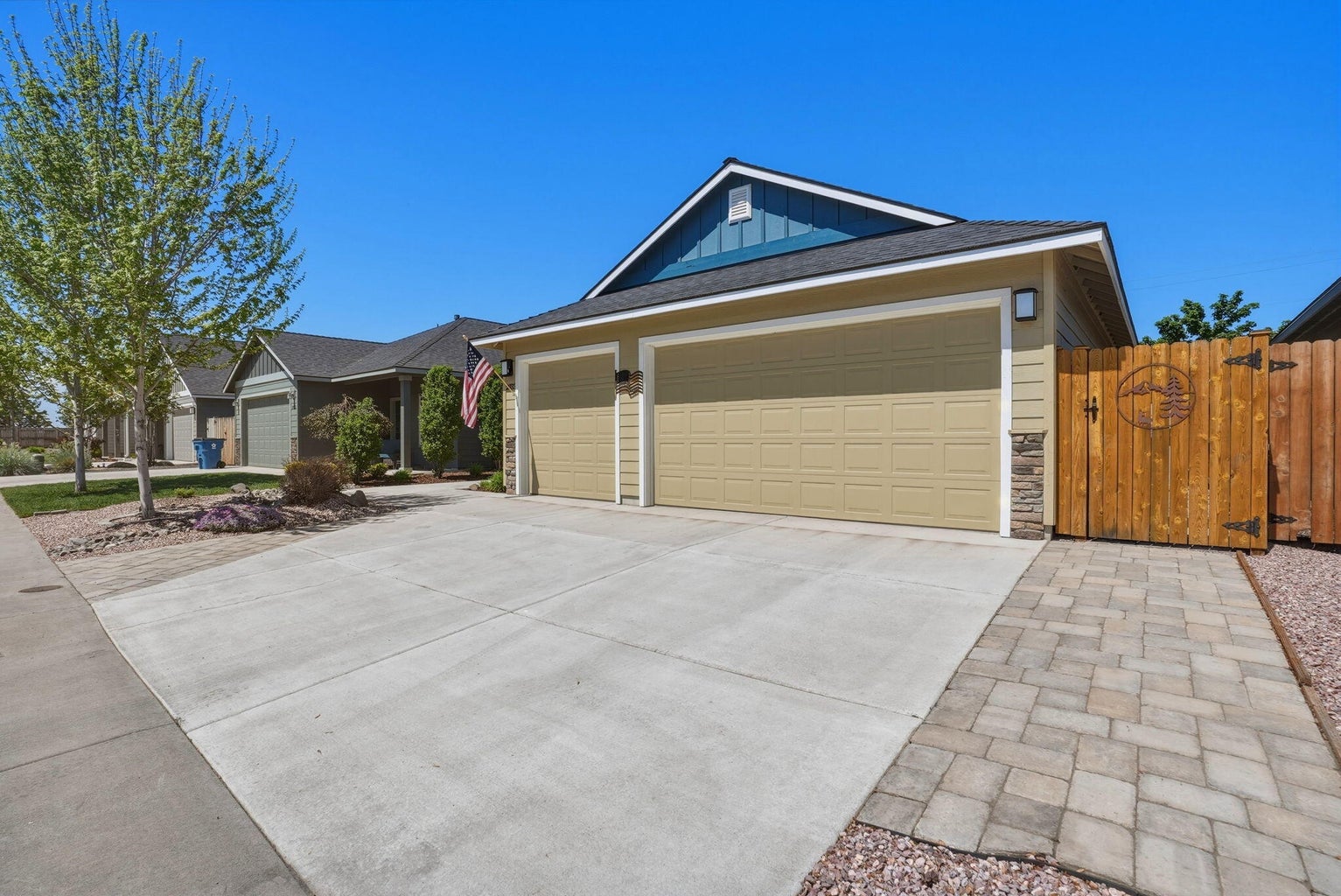 3-car garage with pavers flanking driveway