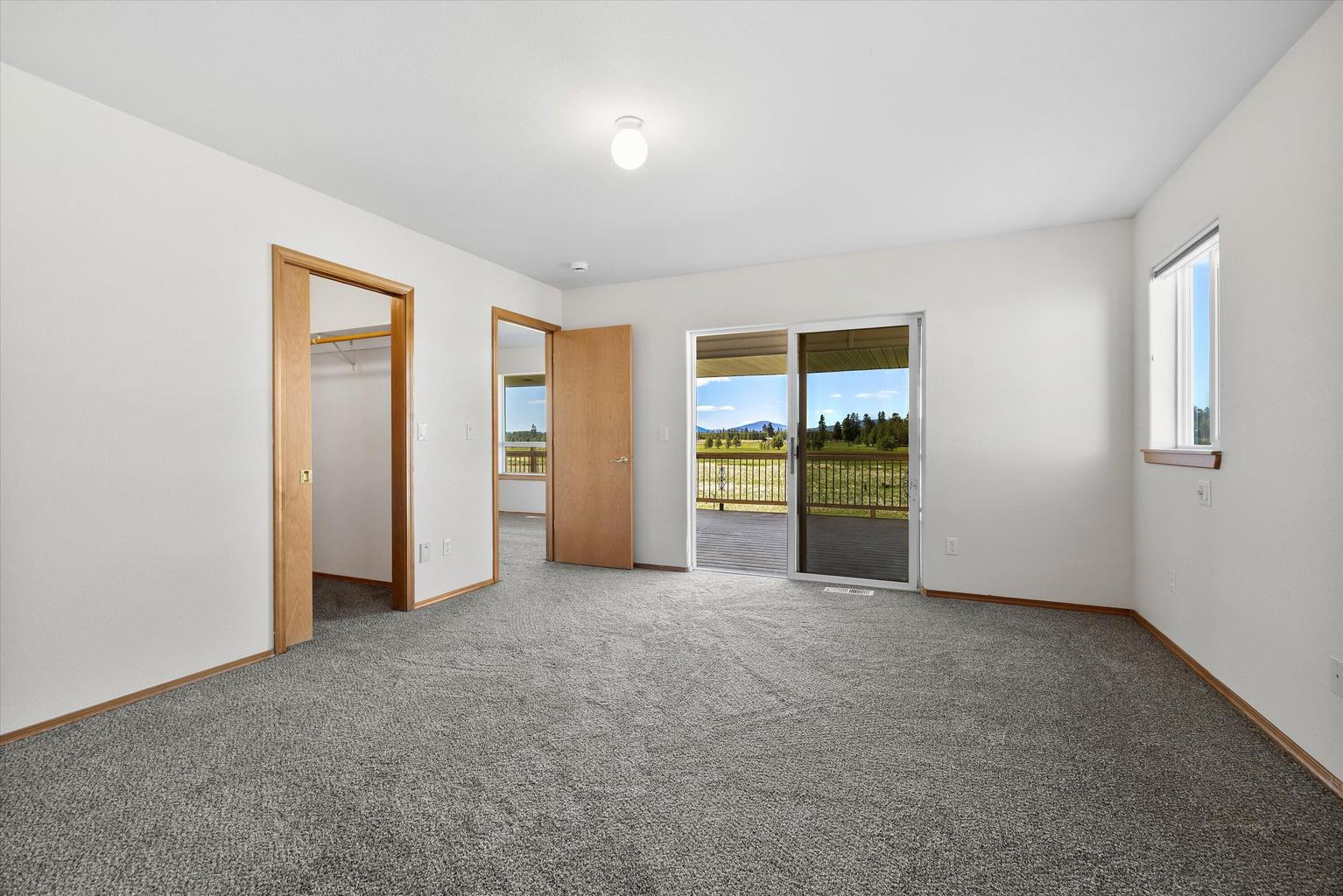Primary has a walk-in closet and opens to the back deck