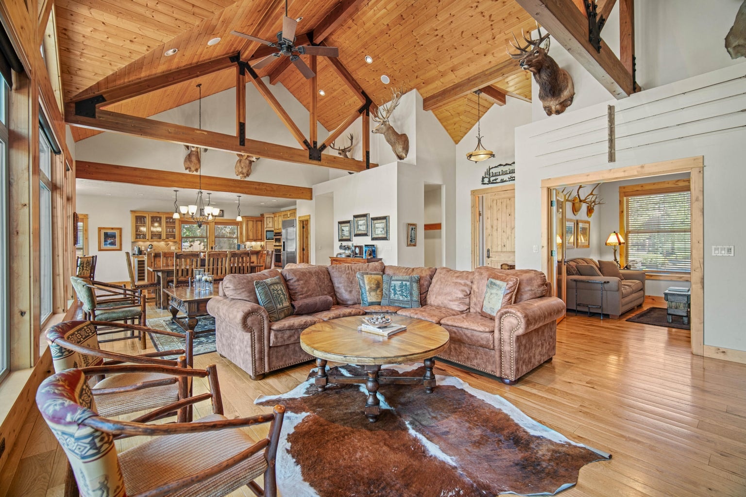 Classic Caldera Springs home built by John Legg. Three suites plus an office on the main floor. Dramatic Caldera Springs great room with vaulted wood ceilings, exposed beams, warm hardwood floors, and an open connection to dining and kitchen spaces.