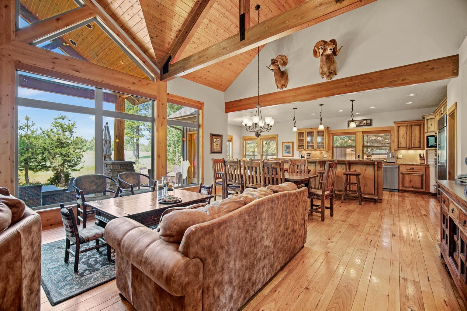 Open living, dining, and kitchen layout designed for gathering, entertaining, and easy indoor-outdoor enjoyment.