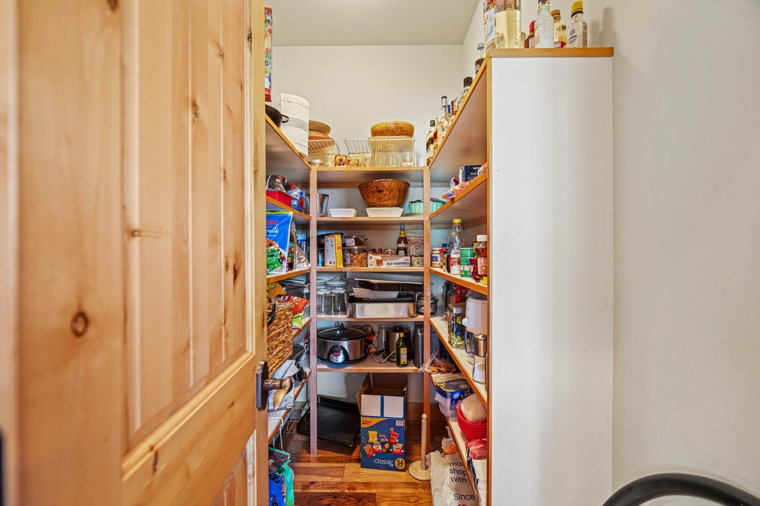 Large walk-in pantry adds practical storage for extended stays, entertaining, and resort living.