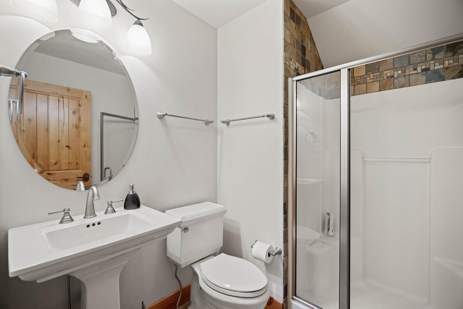 Upstairs bath with pedestal sink, shower, and tile accents, supporting the flexible bonus-level suite.