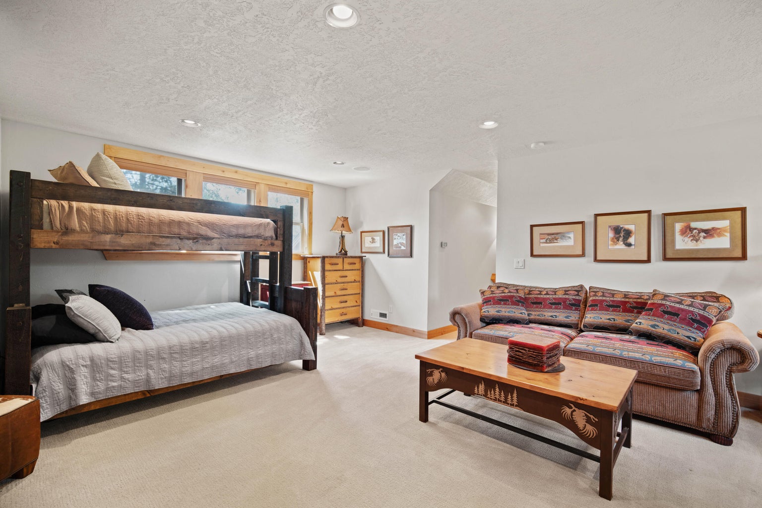 Bonus-level lounge with bunk beds, sofa seating, and room for extended family or guests.
