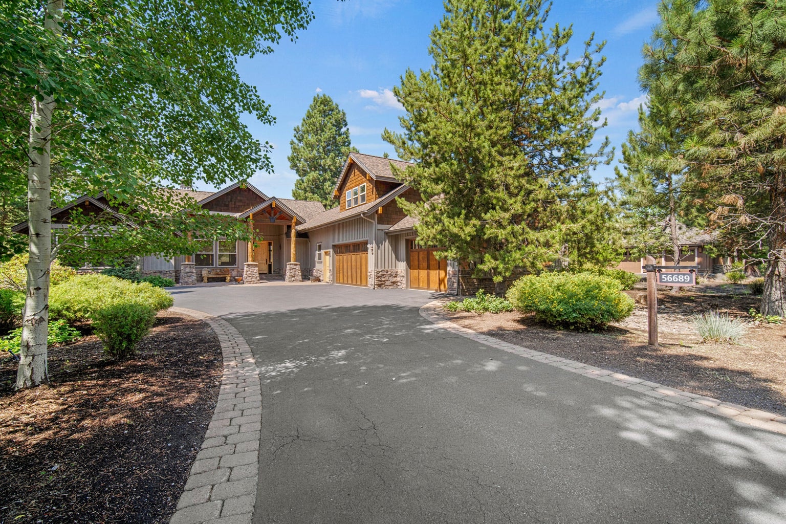Spacious paved driveway and lodge-style exterior create a strong first impression at this Caldera Springs golf community home.