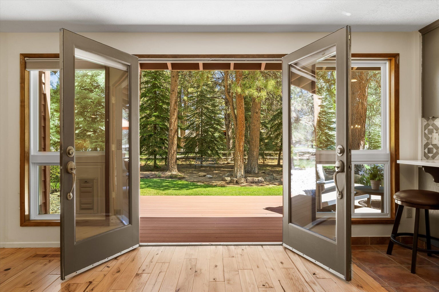 Full light doors frame the view to the gorgeous rear yard