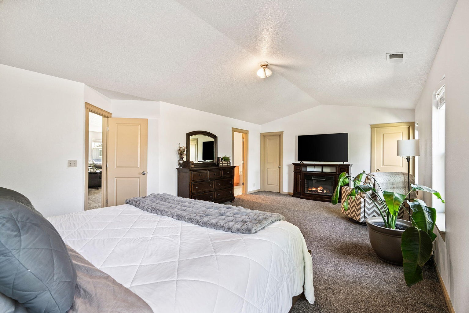 oversized primary suite with dual walk in closets