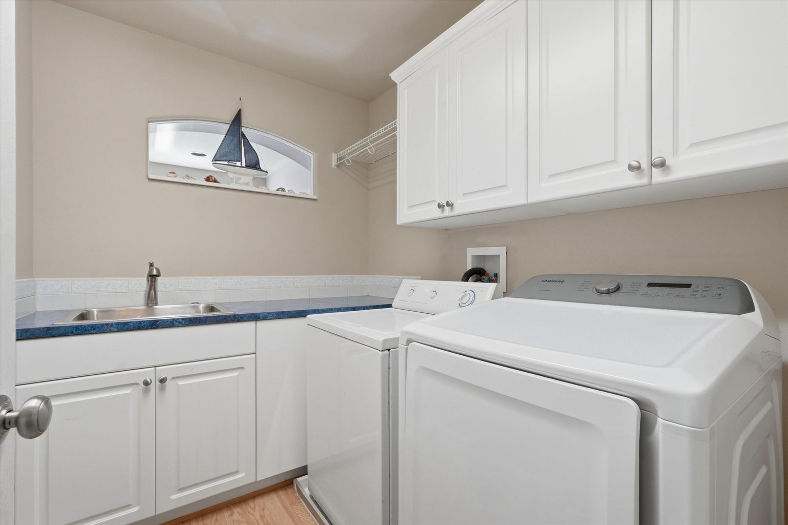 Spacious laundry room with utility sink and ample storage space