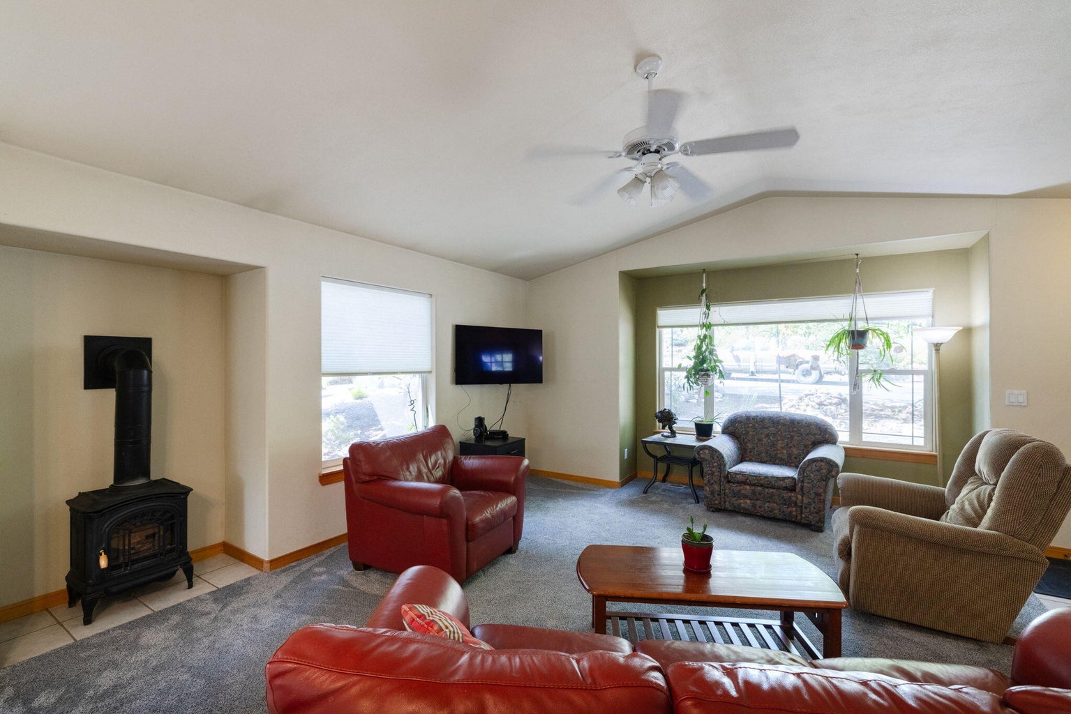Great room with lots of windows, vaulted ceilings, new carpet, and easy-to-use stove.