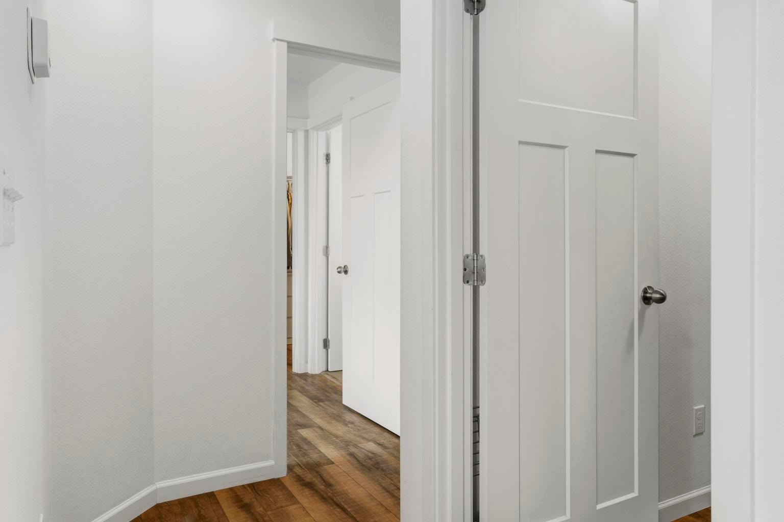 Hallway from kitchen area to primary suite