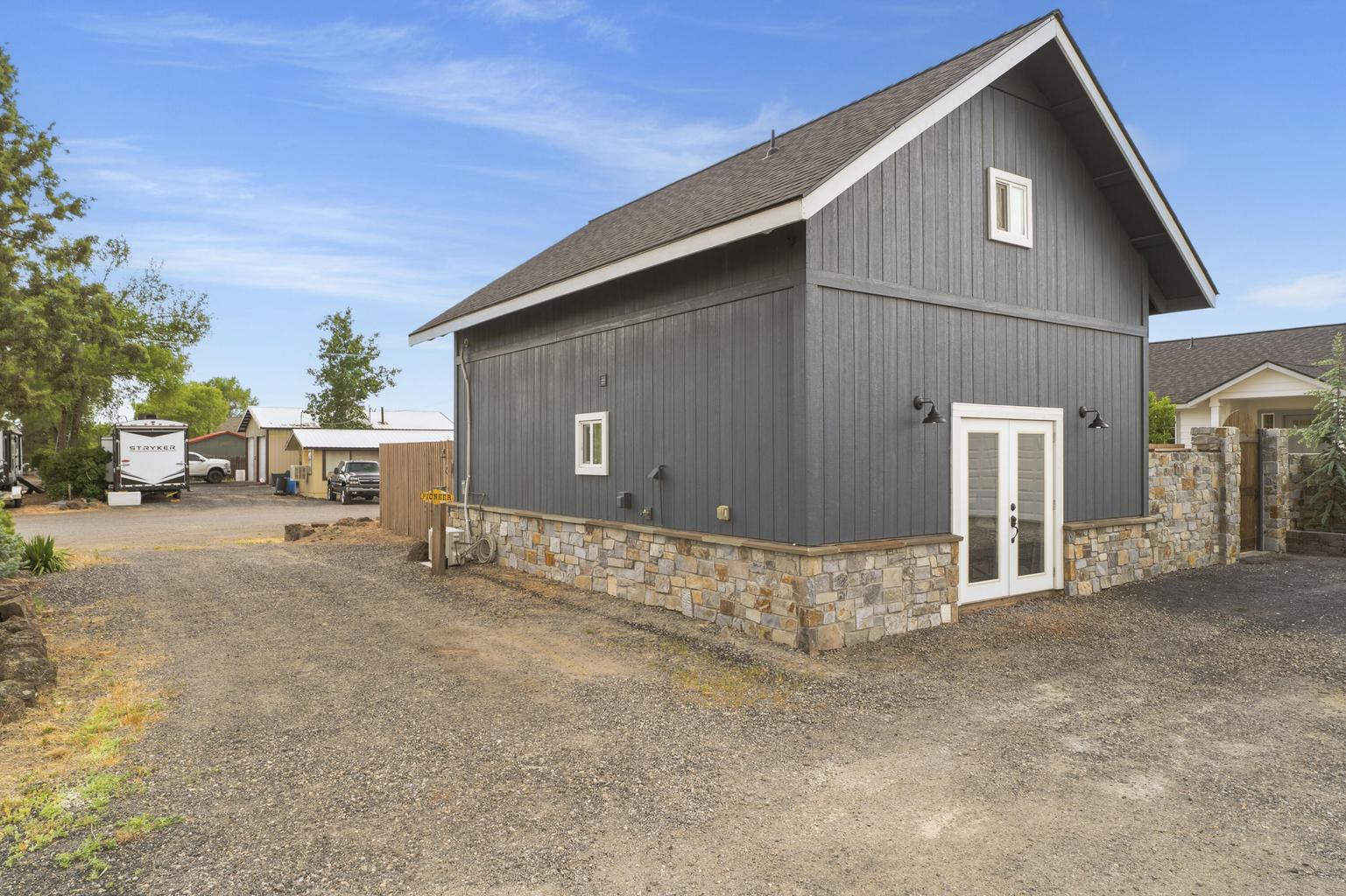 Side entrance from driveway to pottery studio. RV Hookups along wall