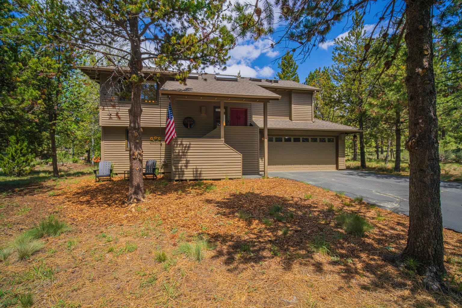 Front elevation framed by Ponderosa pines in Fairway Point Village.