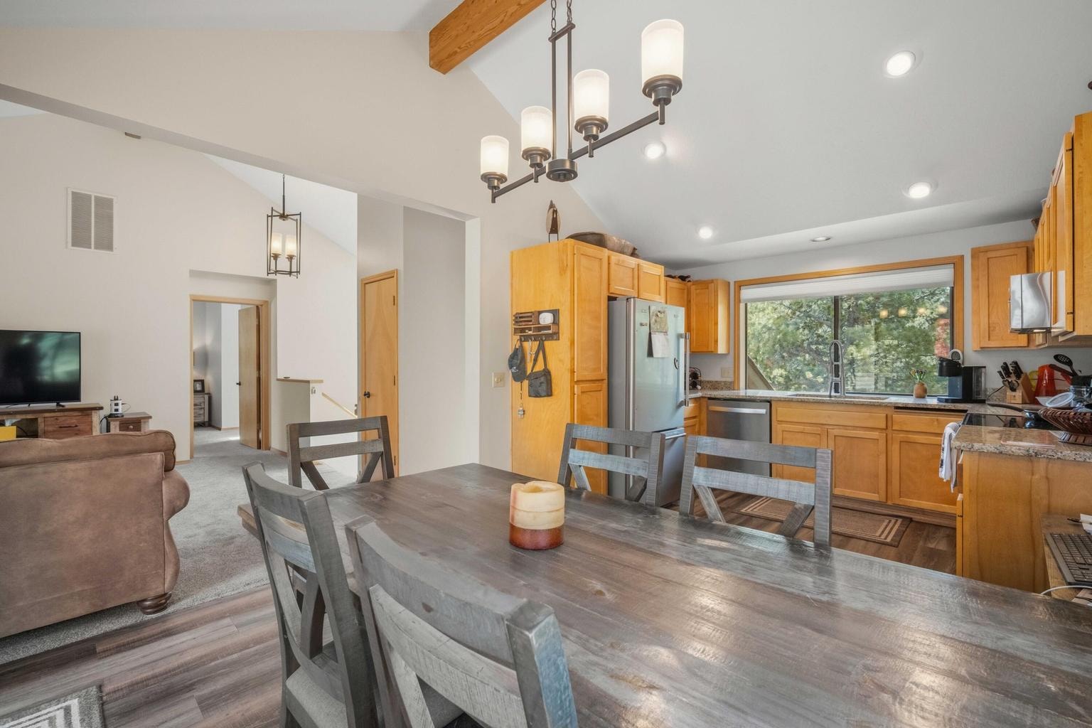 Open kitchen and dining area with vaulted ceiling and casual Sunriver gathering space.