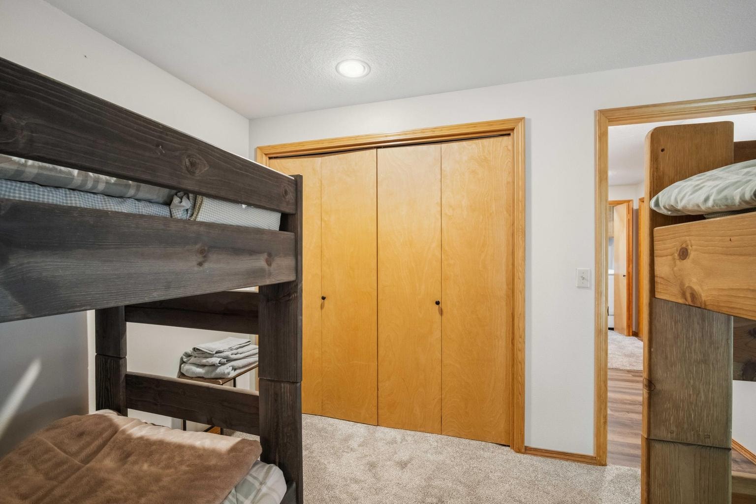 Bunk room with closet storage and easy access to the lower-level hall.