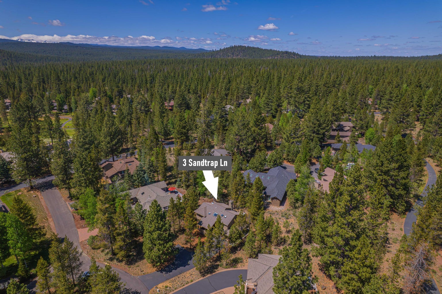 Aerial neighborhood view identifying the home’s quiet Sandtrap Lane location.