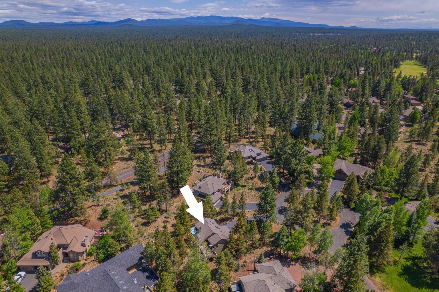 Expansive aerial view toward the Cascades and surrounding Sunriver forest.