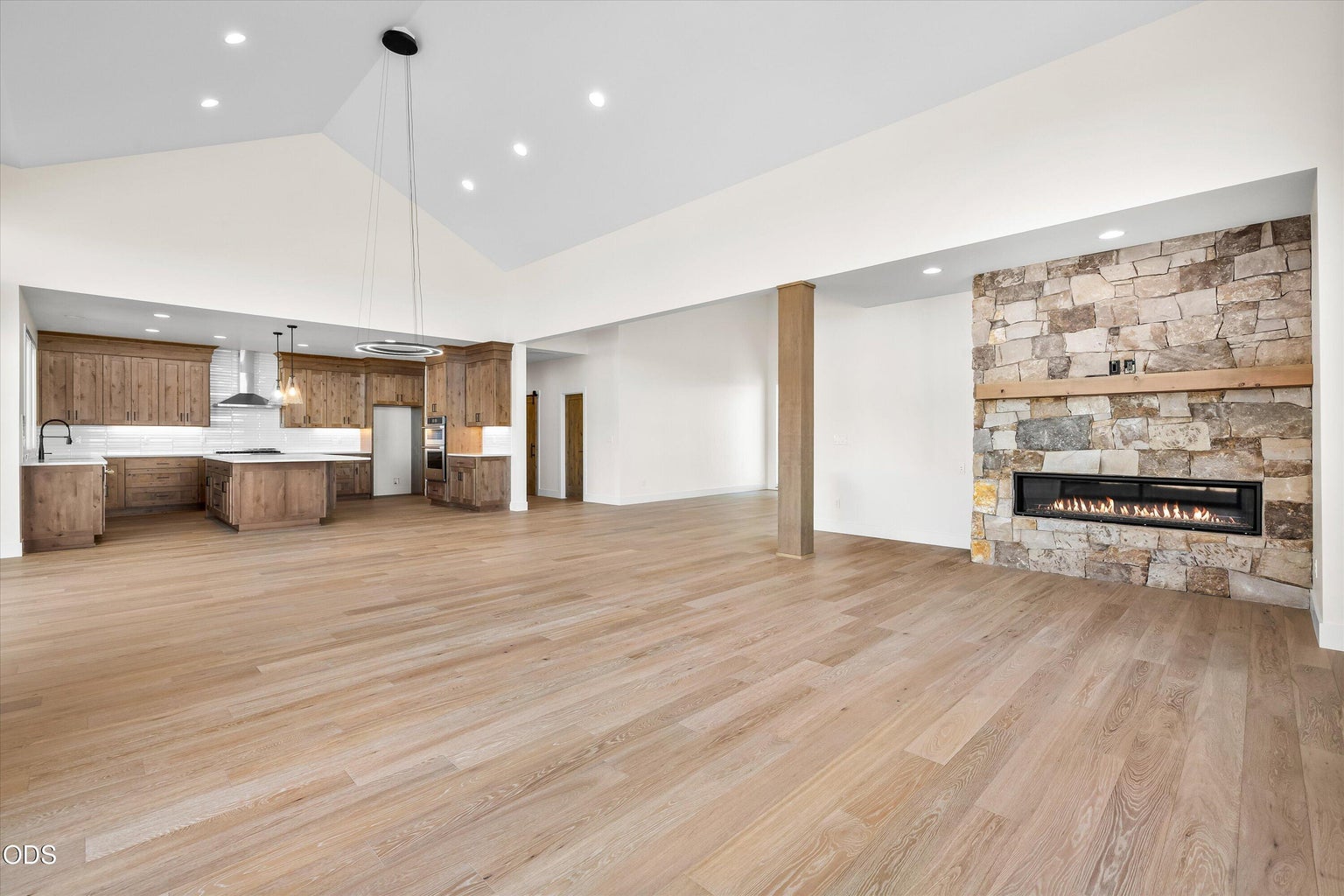 Open living space with kitchen tucked into side, nice separated foyer, hallway, powder room, pantry