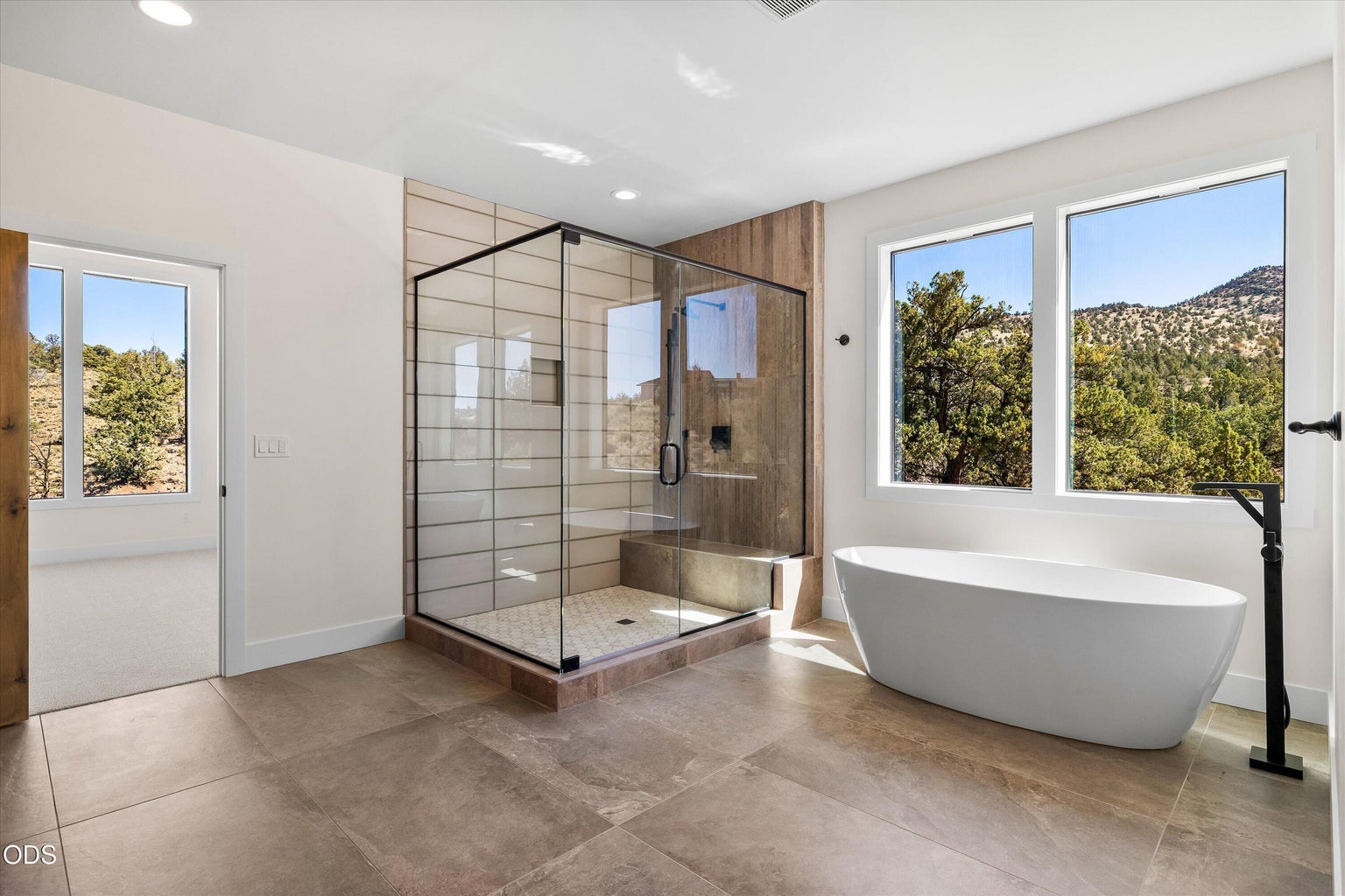 The primary bathroom is massive with walk-in shower and separate soaking tub - and more windows and privacy in nature