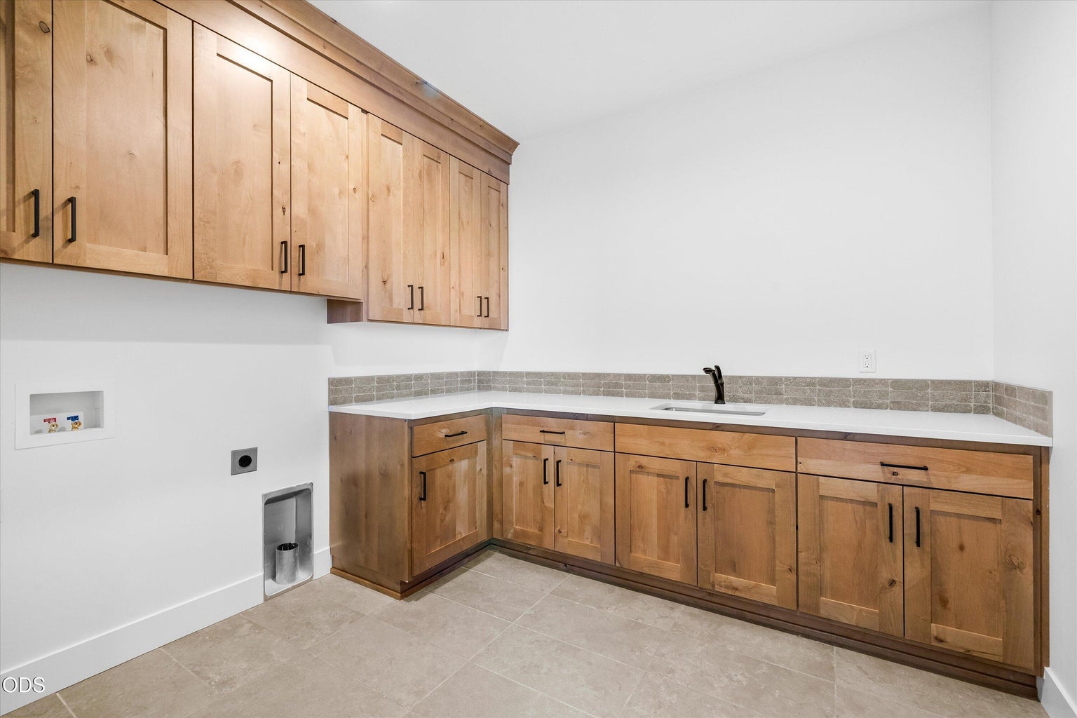 Spacious laundry with mud sink and storage