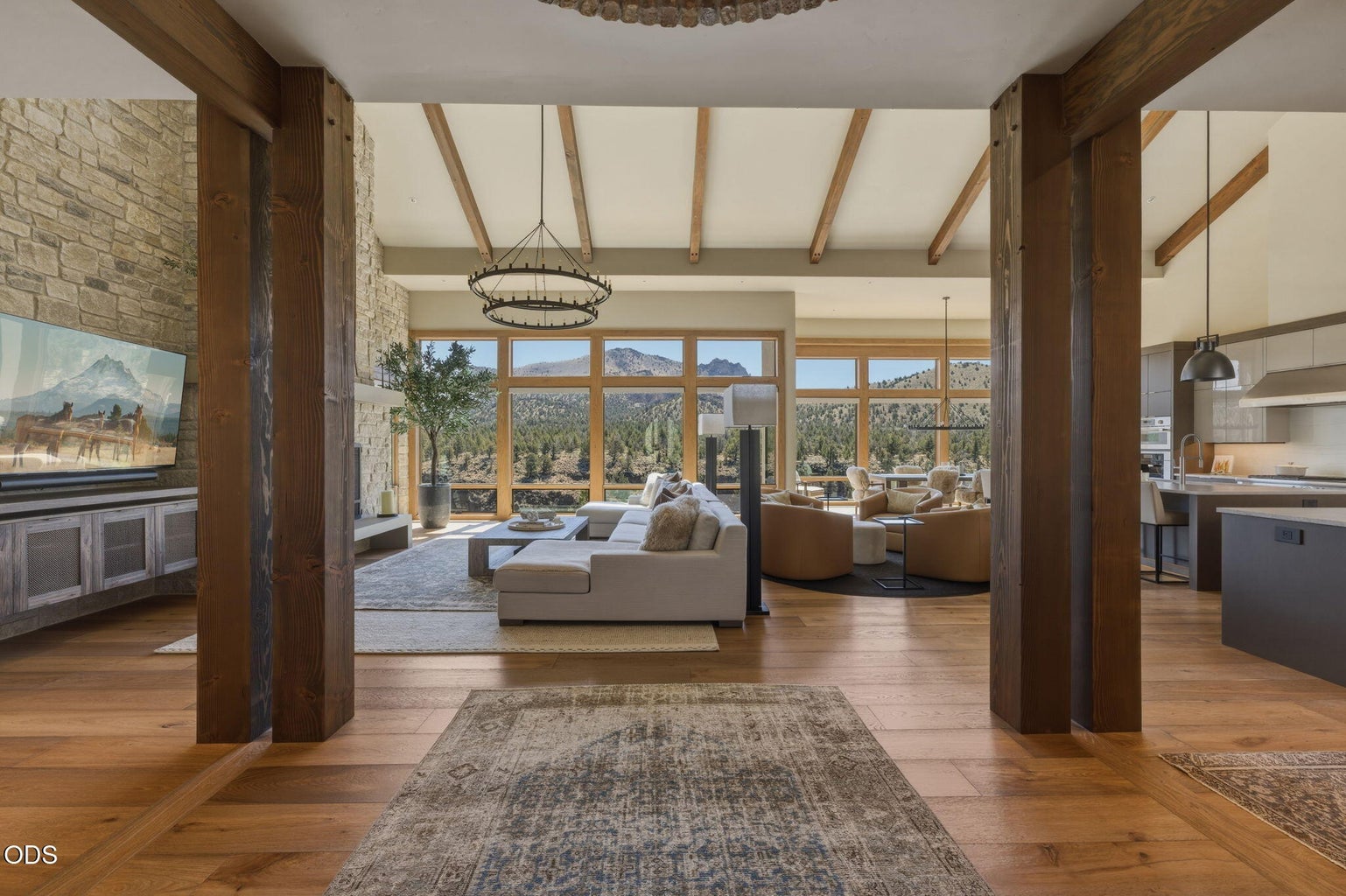 Great room entry, wood beam ceiling, stone fireplace, open plan to kitchen, Smith Rock views