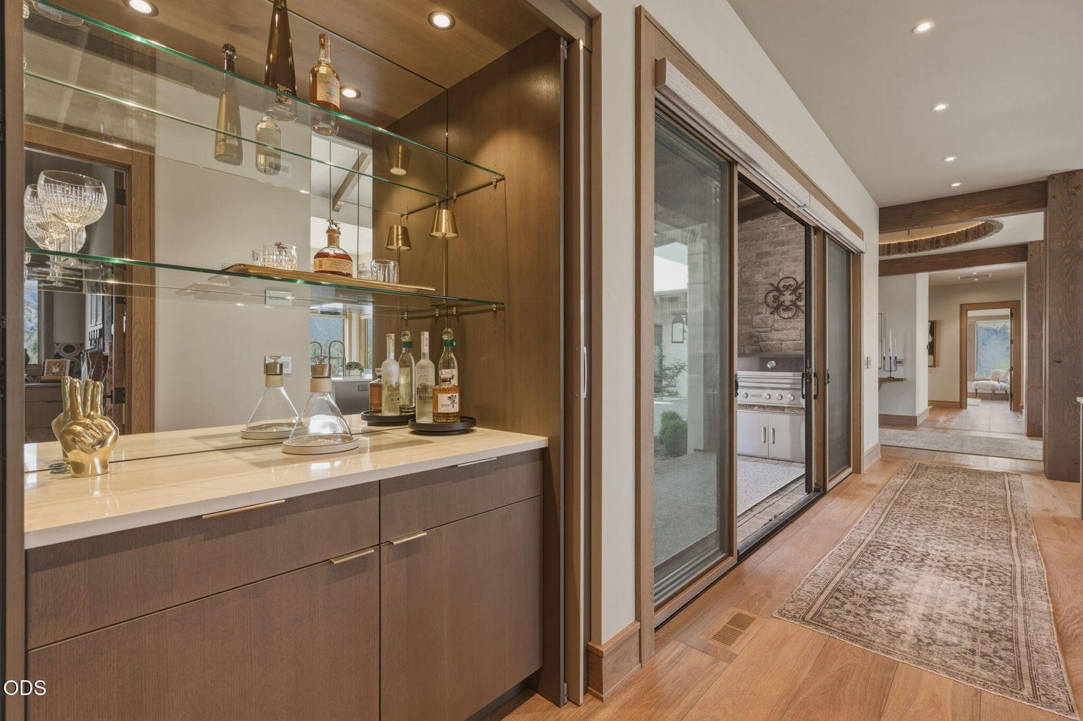 Bar niche with mirrored shelving, hallway to courtyard access and main living