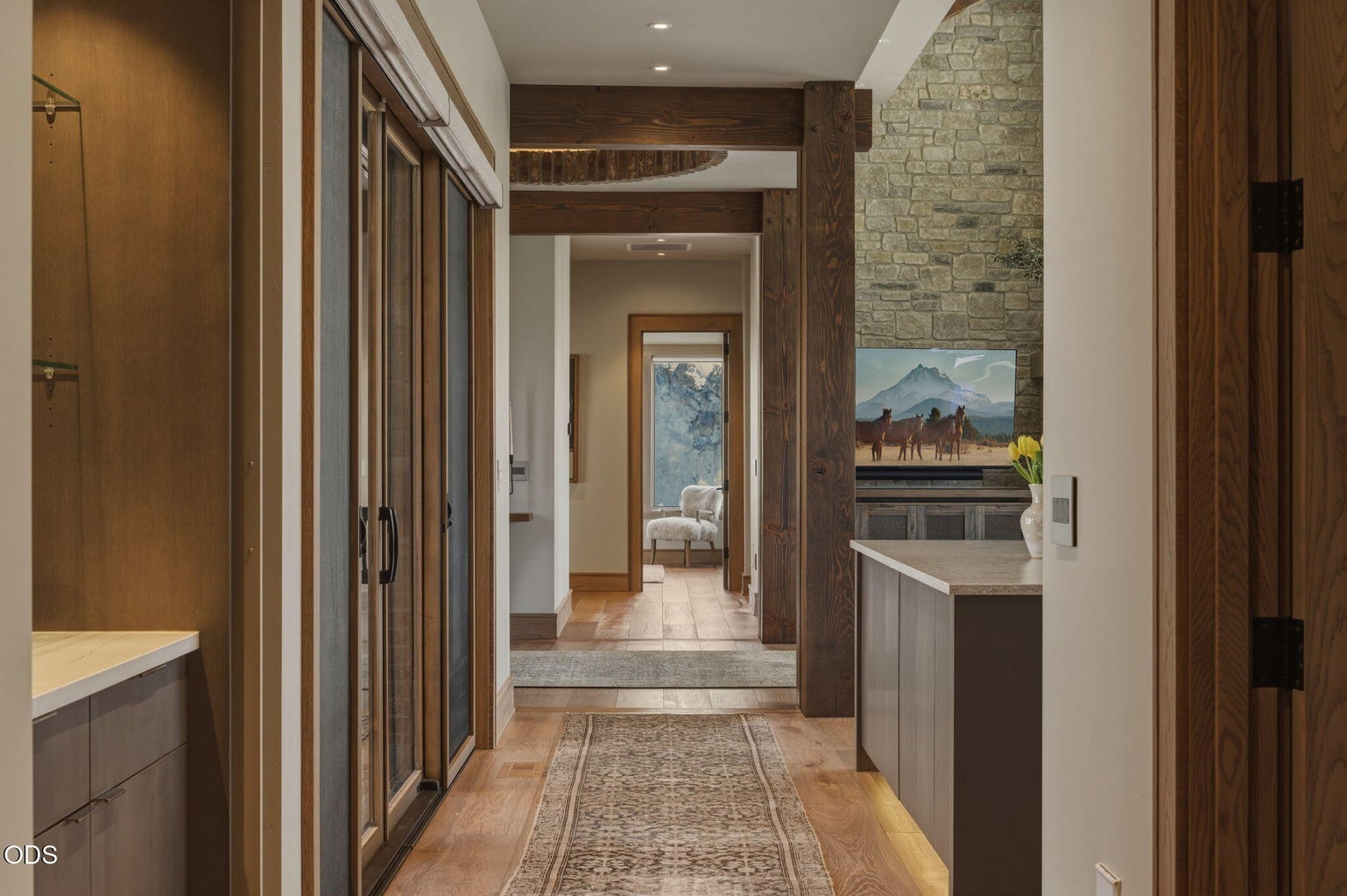 Hallway from kitchen to primary wing, timber beams