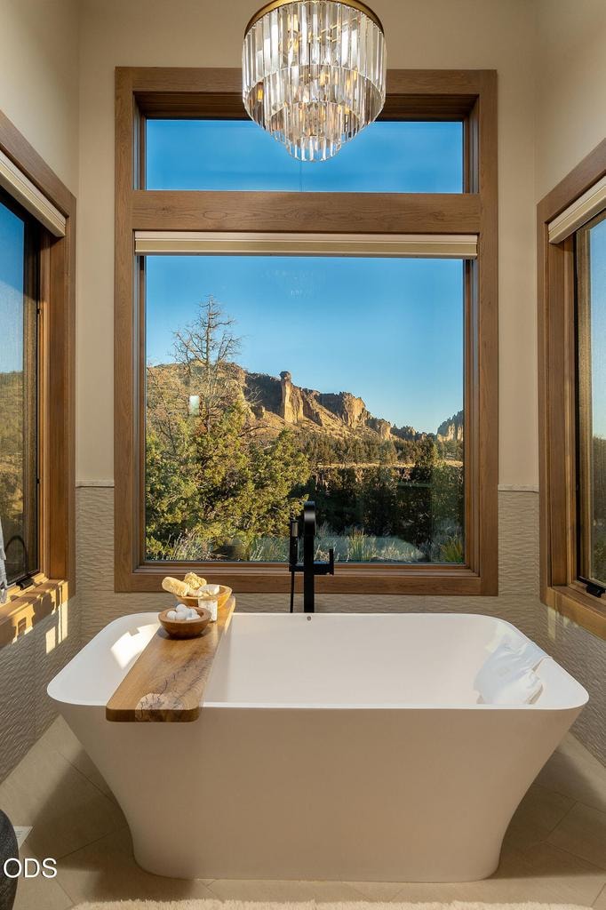 Freestanding soaking tub, crystal chandelier, direct Smith Rock view