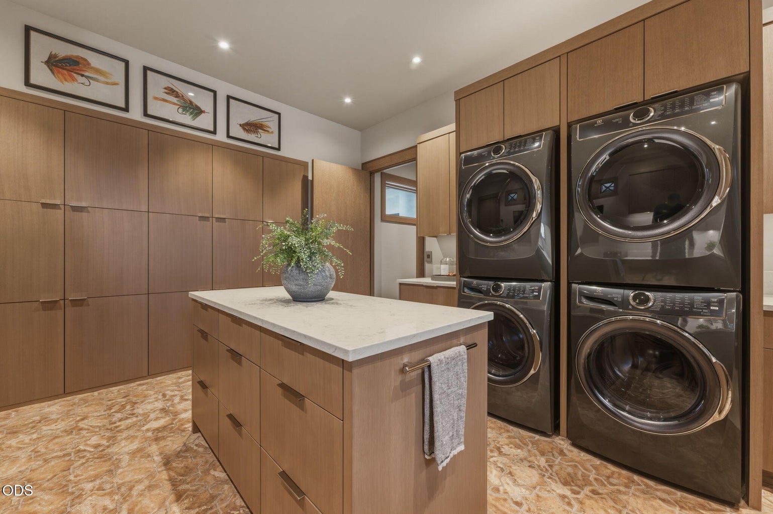 Laundry room, dual stacked washer/dryer sets, custom cabinetry, center island