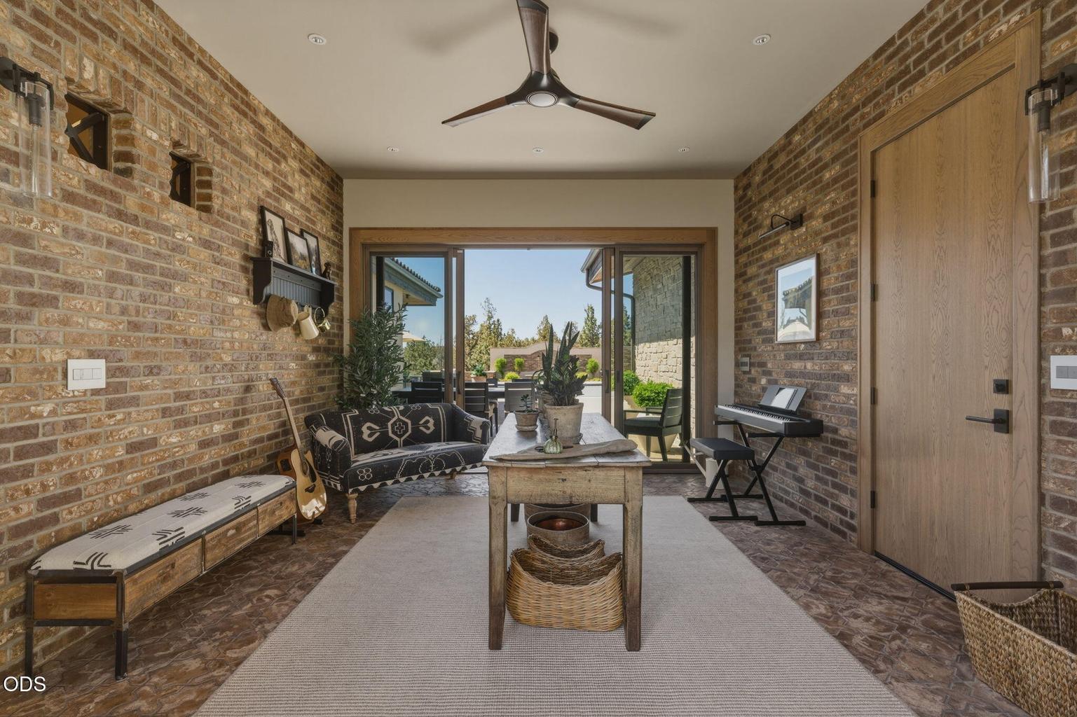 Transitional space, exposed brick walls, slider to pool area