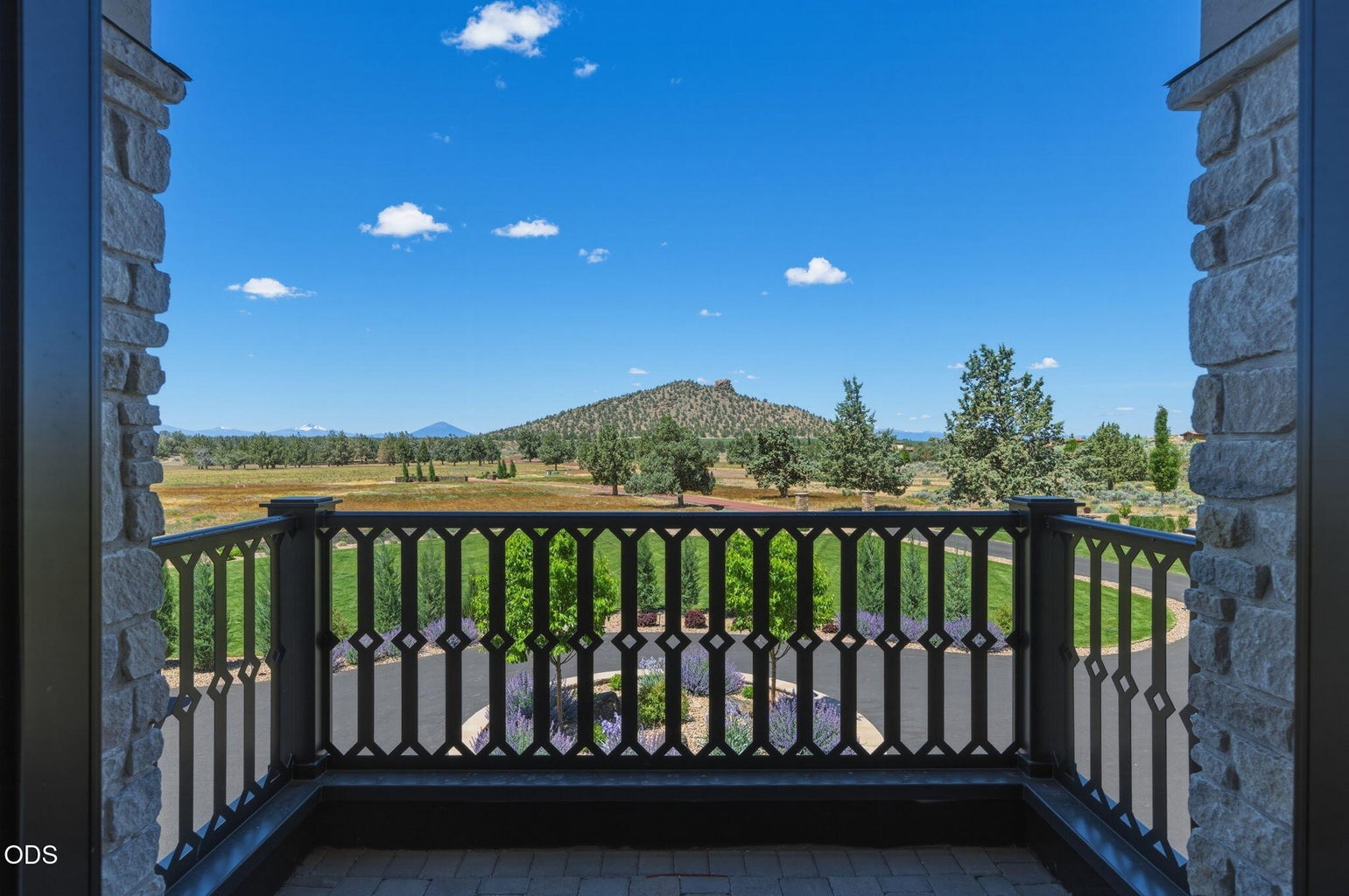 Upper balcony looking out over circular drive, lavender plantings, Cascade mountain backdrop