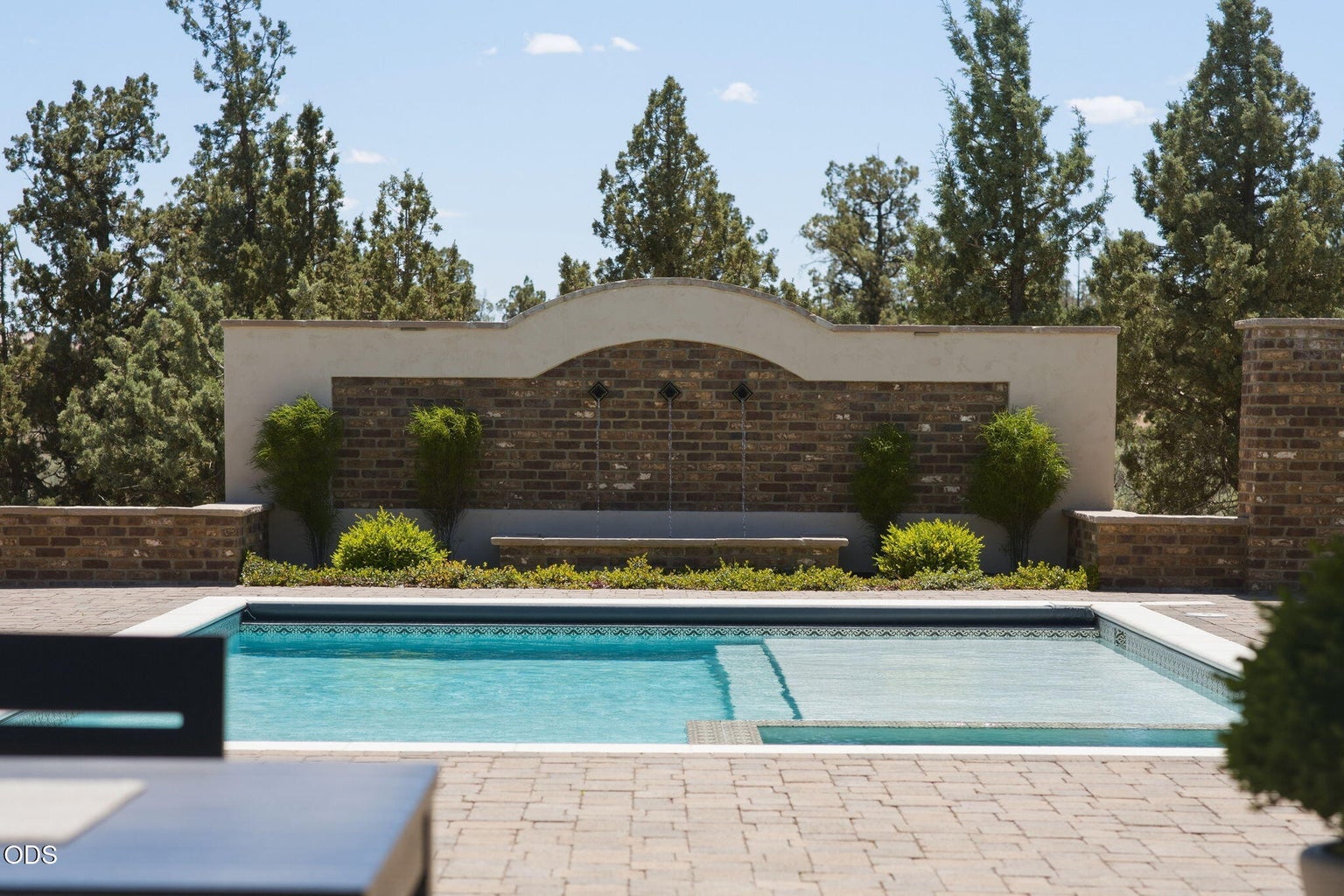 Pool with water feature wall, spa, paver surround