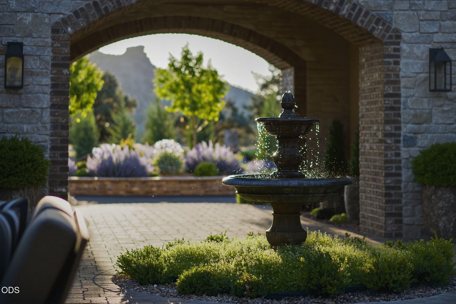 Courtyard fountain, arched passageway, and Smith Rock in background