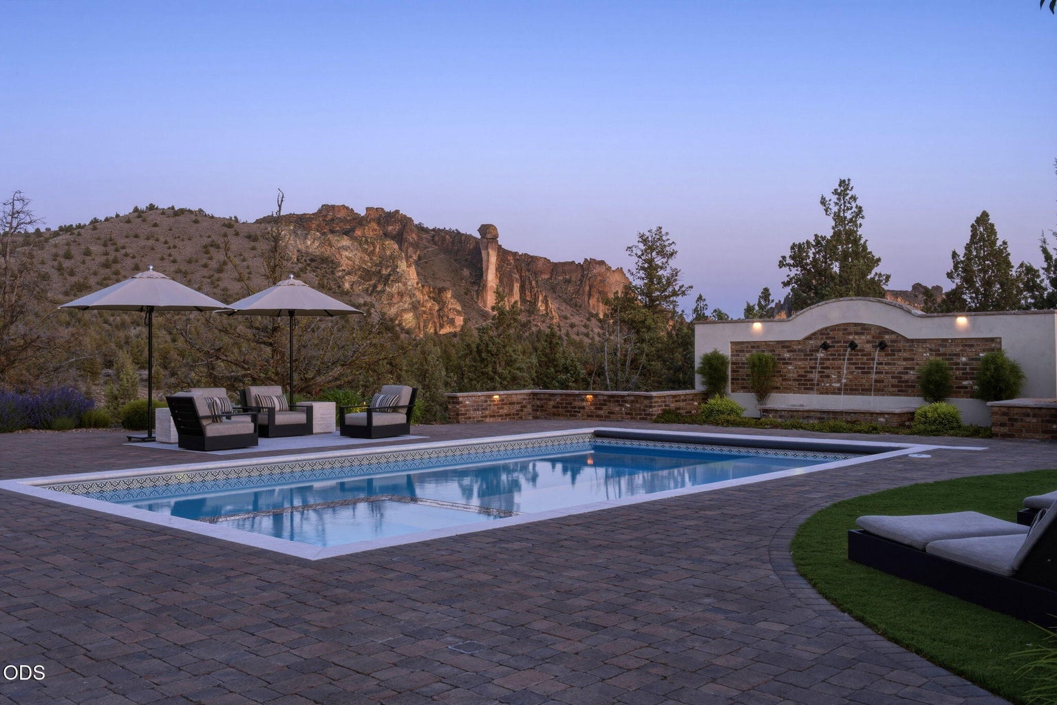 Pool at dusk, Smith Rock in view, lounge seating