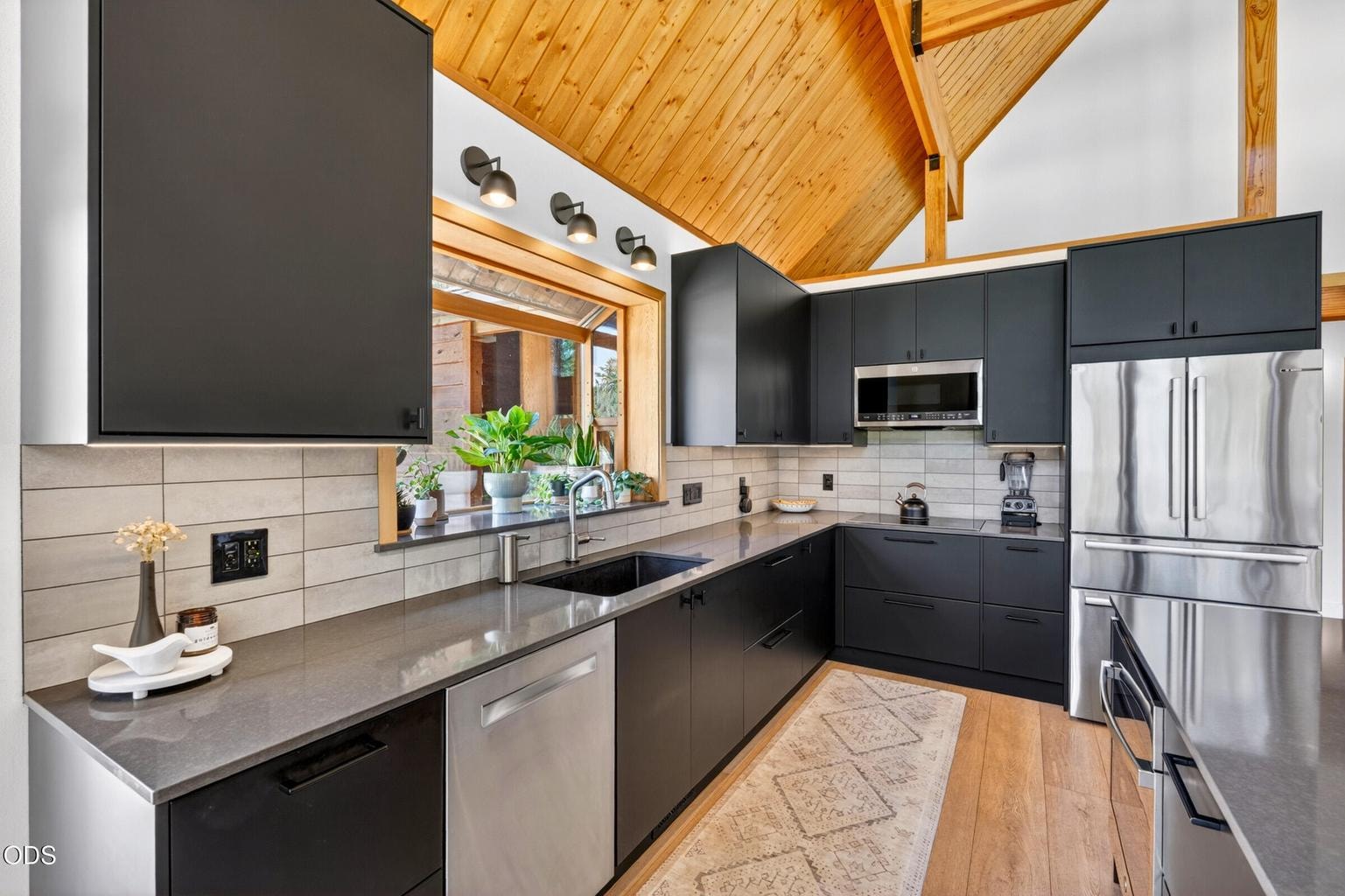 Kitchen with new stainless steel appliances.