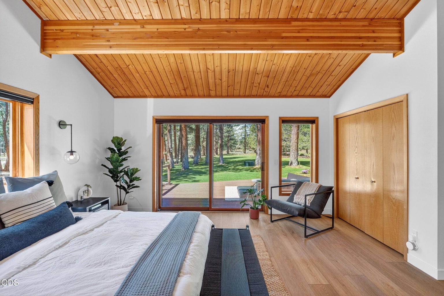 Primary bedroom with a deck out the slider
