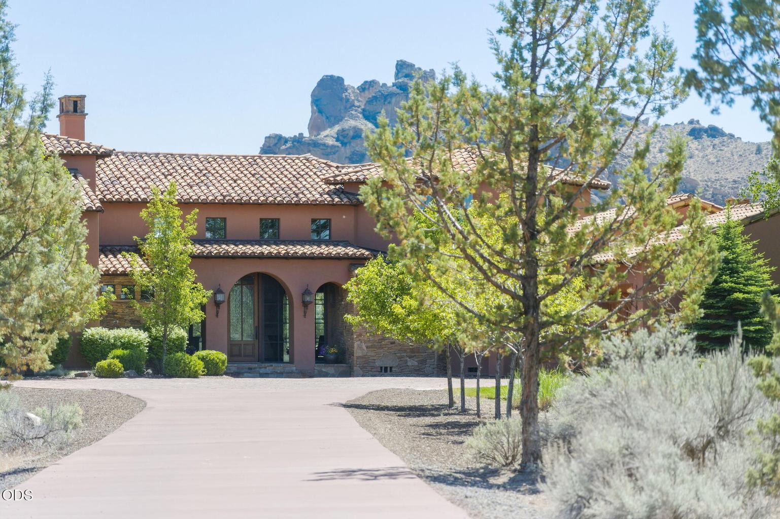 Entry to estate with Smith Rock in the background