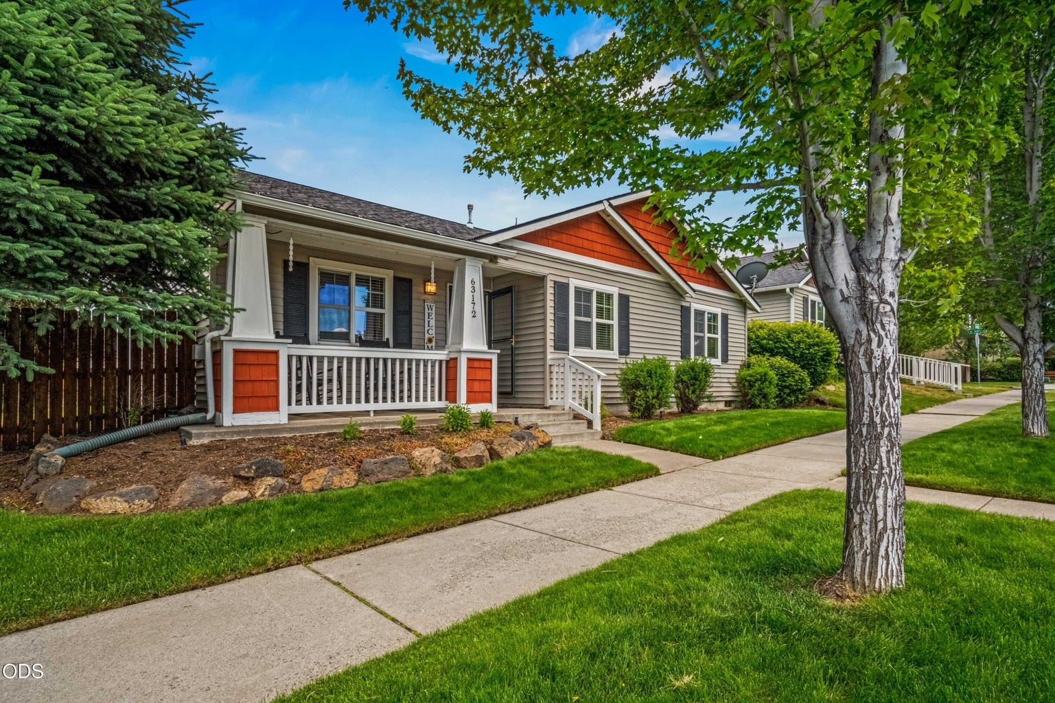 A welcoming front approach highlights the home’s single-level design, mature landscaping, and attractive neighborhood setting in Bend’s Empire Crossing community.