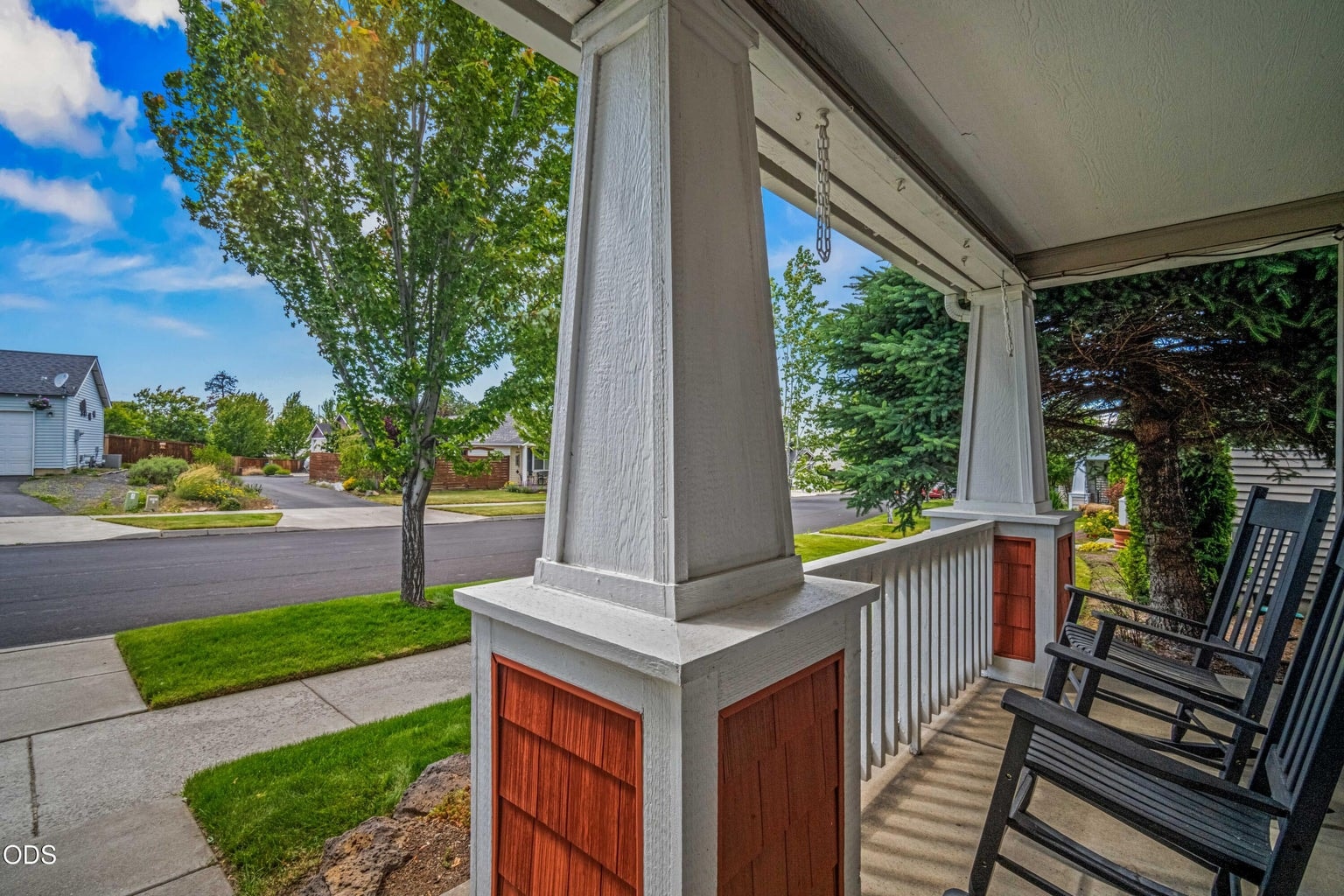 The covered front porch offers a pleasant spot for morning coffee, conversation, or simply enjoying the neighborhood setting.