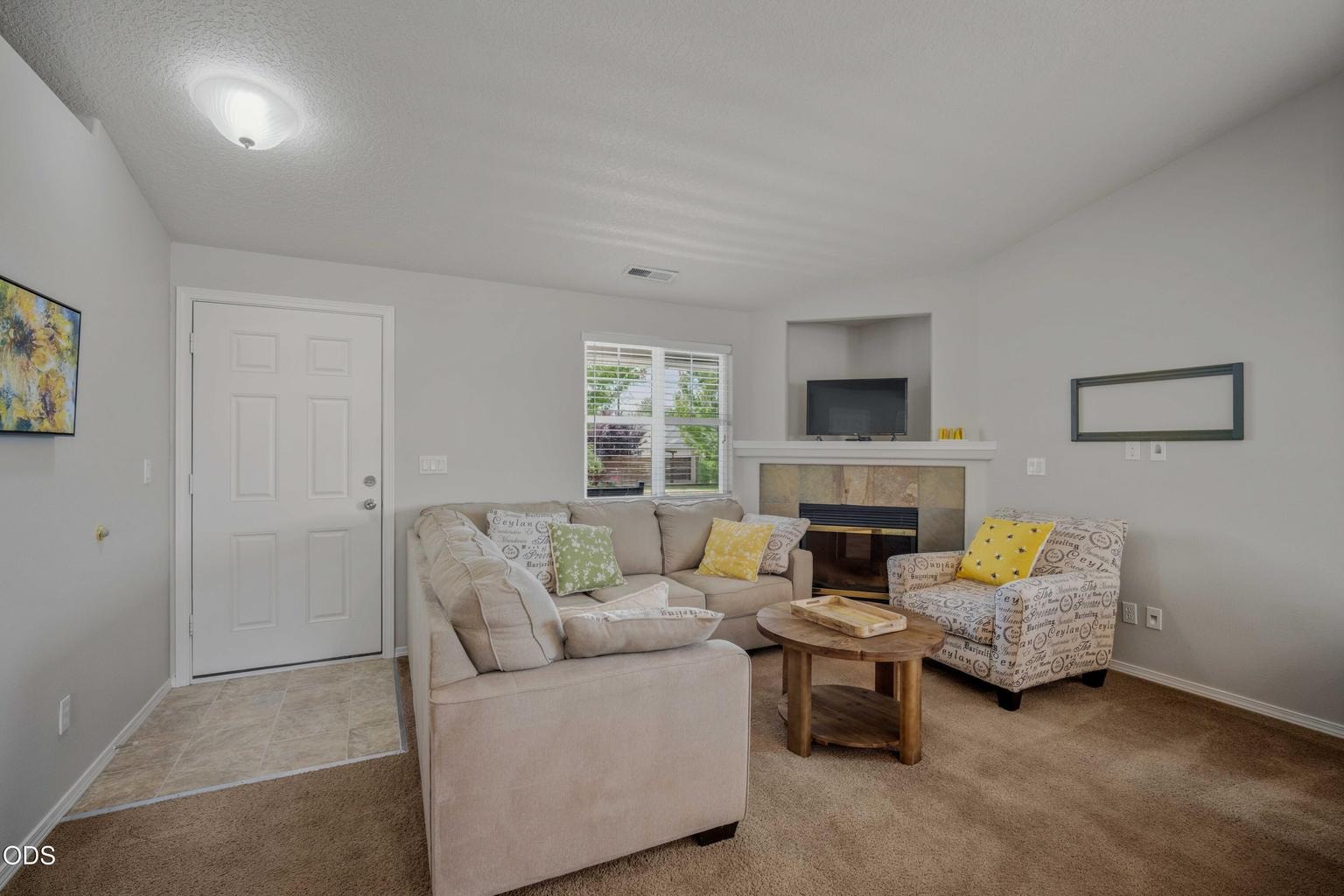 The living room is anchored by a gas fireplace, adding warmth and a comfortable central gathering space for relaxing at home.