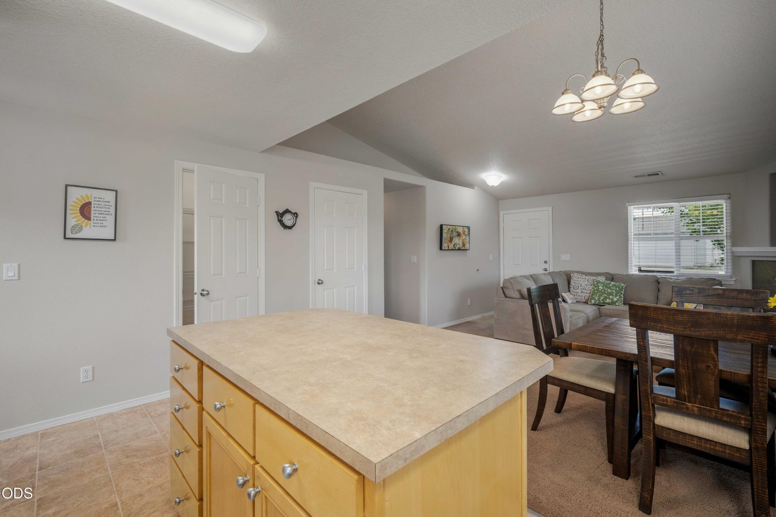 The kitchen island and adjacent dining area support both everyday meals and relaxed entertaining.