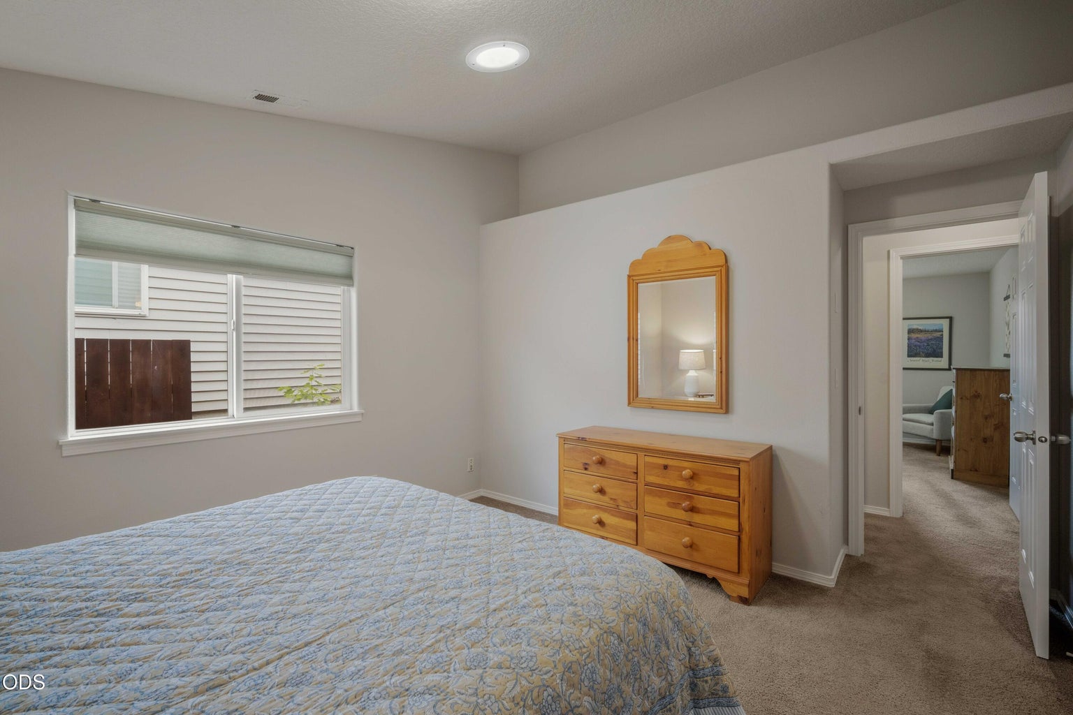 Another view of the primary bedroom highlights its easy layout and private connection to the en suite bath.