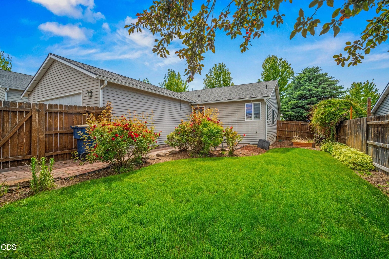 A well-kept lawn and mature landscaping create a comfortable outdoor setting with room to enjoy Bend’s sunny seasons.