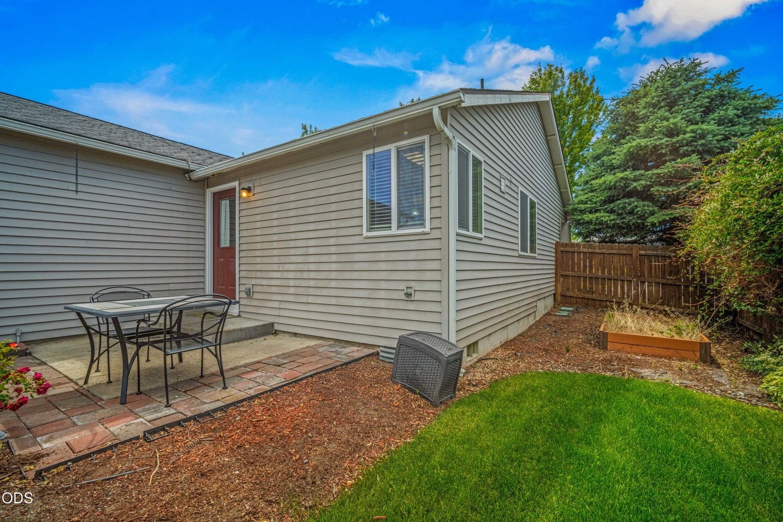 The rear patio connects easily to the home and offers a practical outdoor space for dining, grilling, or relaxing.