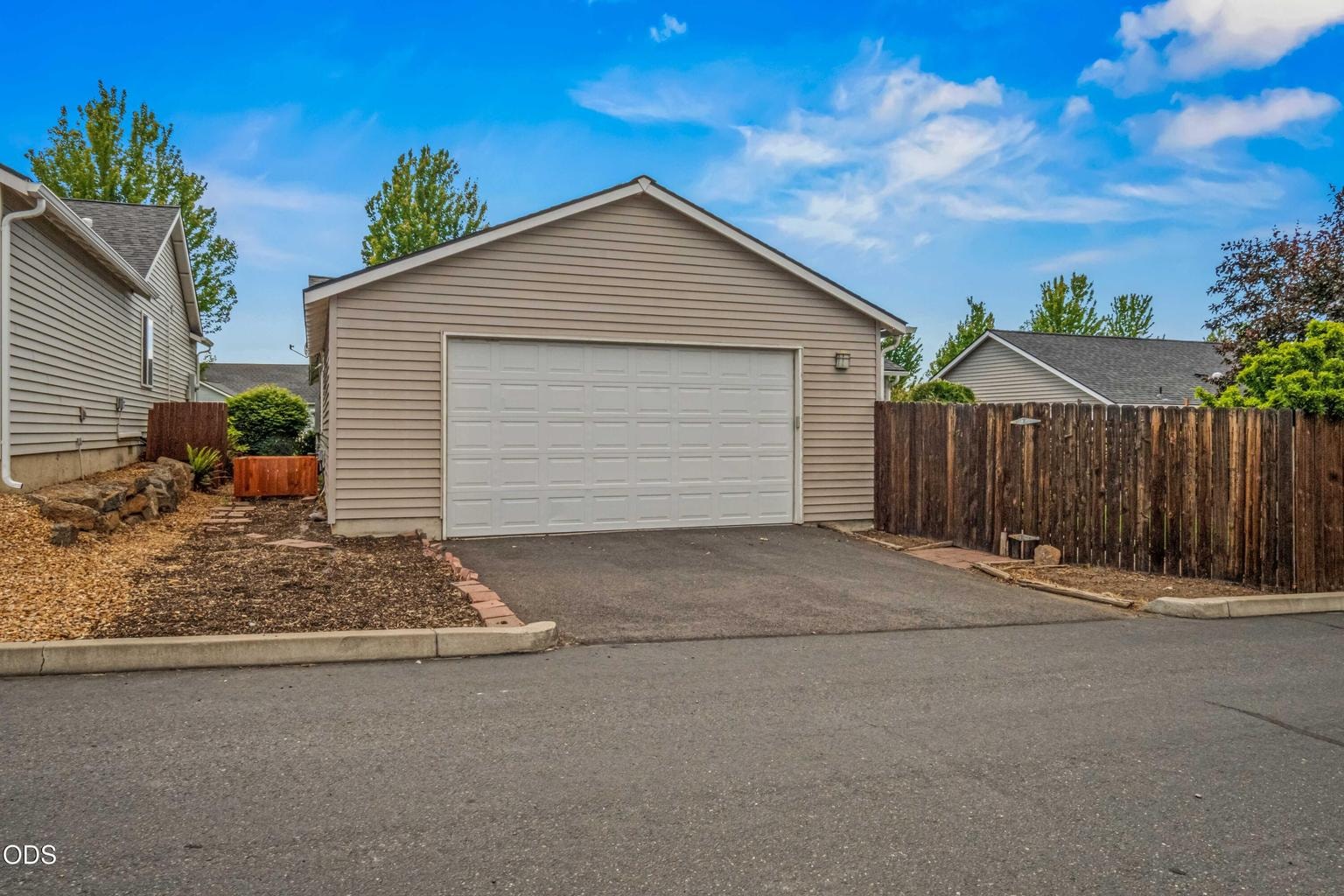 The rear garage approach provides practical alley access, off-street parking, and valuable space for storage, tools, bikes, or Central Oregon gear.