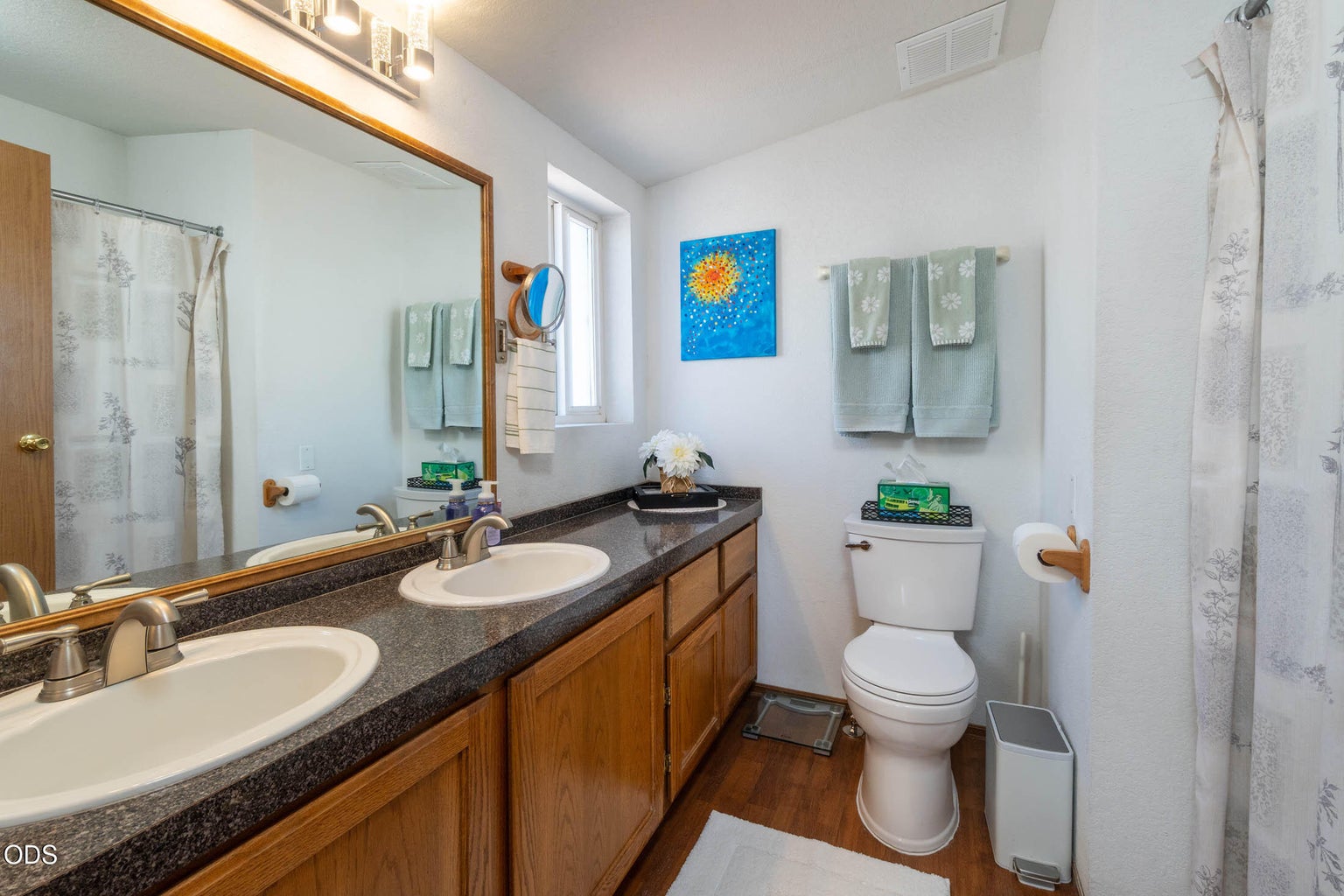 Primary en-suite, boasts double vanity, new lighting, newer nickel faucets, right height toilet and tub/shower.