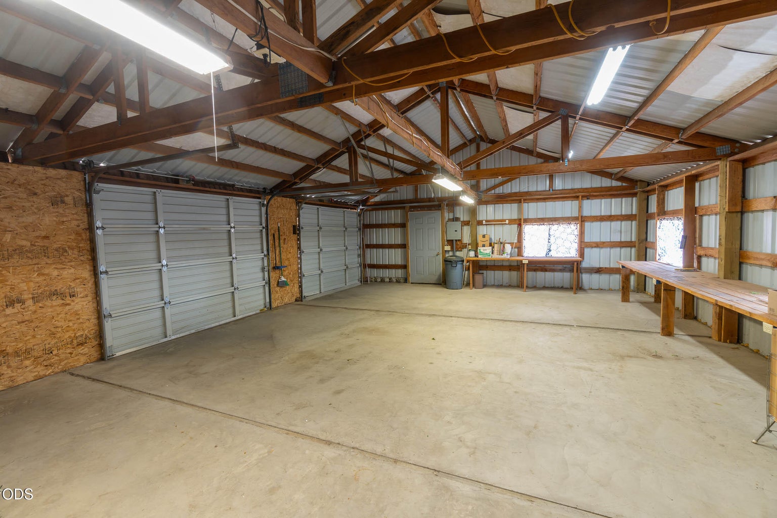 2 overhead doors and man door for shop, with concrete floors.