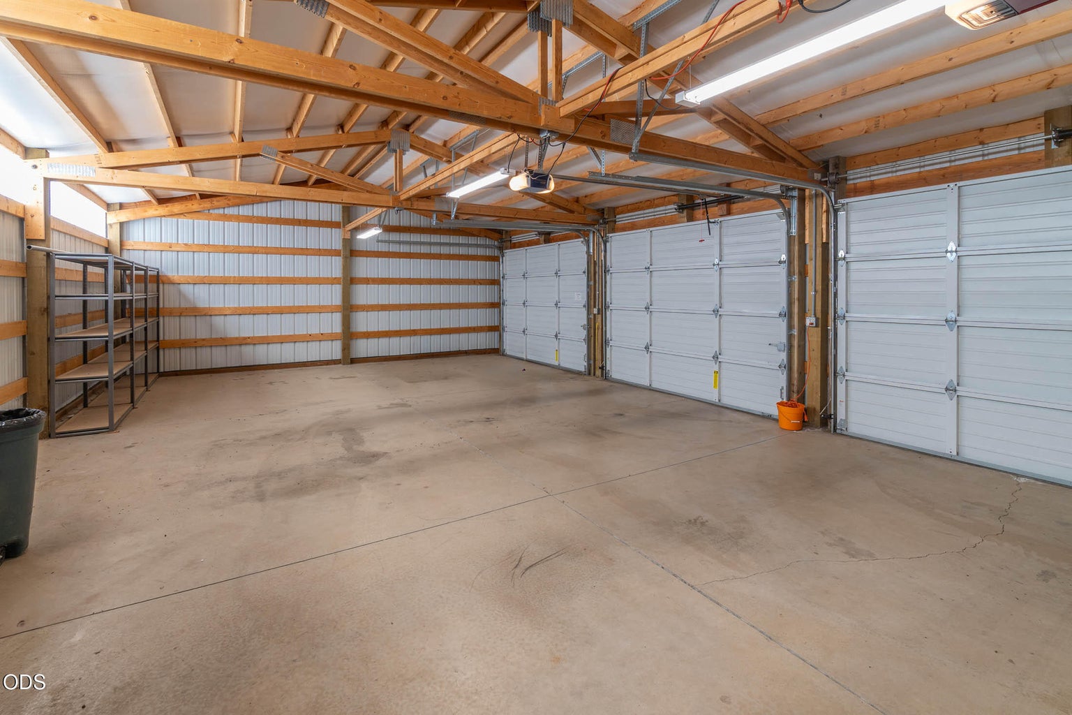 Three car garage, with 3 overhead doors, 2 door openers, concrete floors and room for storage.