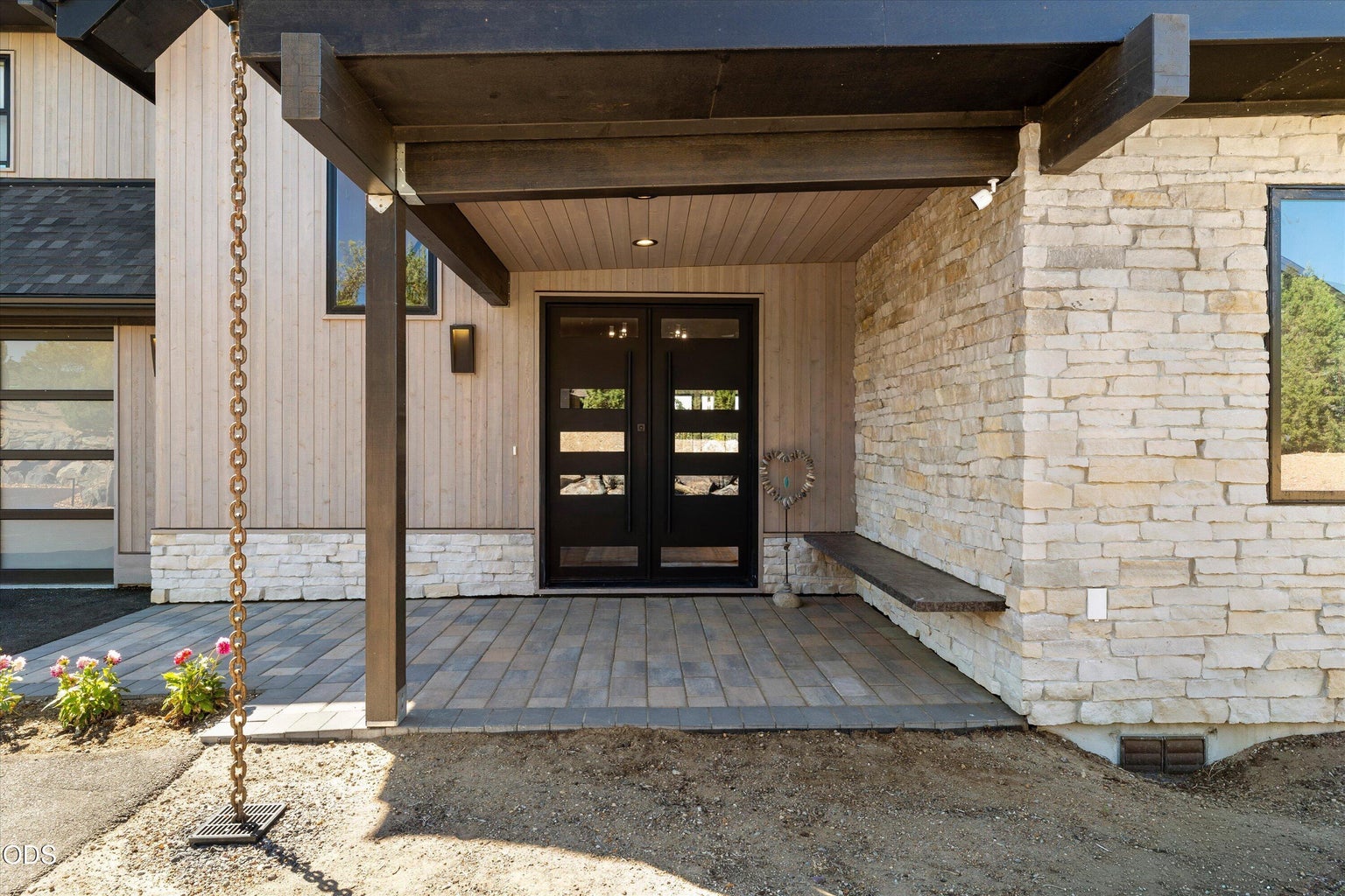 Stately double doors from a covered front patio open to a grand foyer