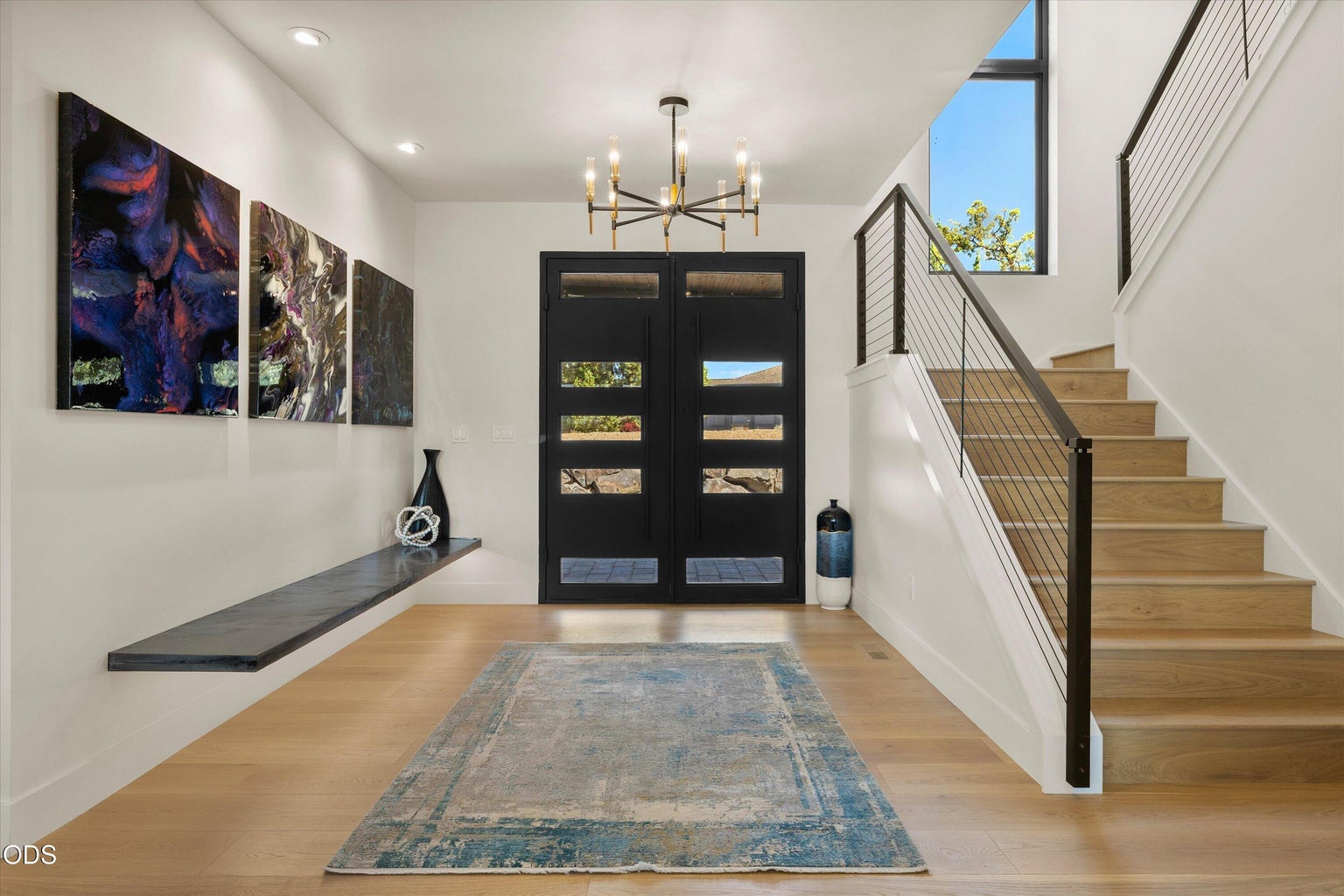 The foyer connects the staircase, garage, powder room, hall to primary bedroom, and kitchen