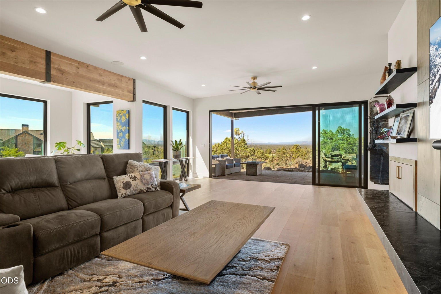 The focal point are the mountains, framed by vanishing glass doors