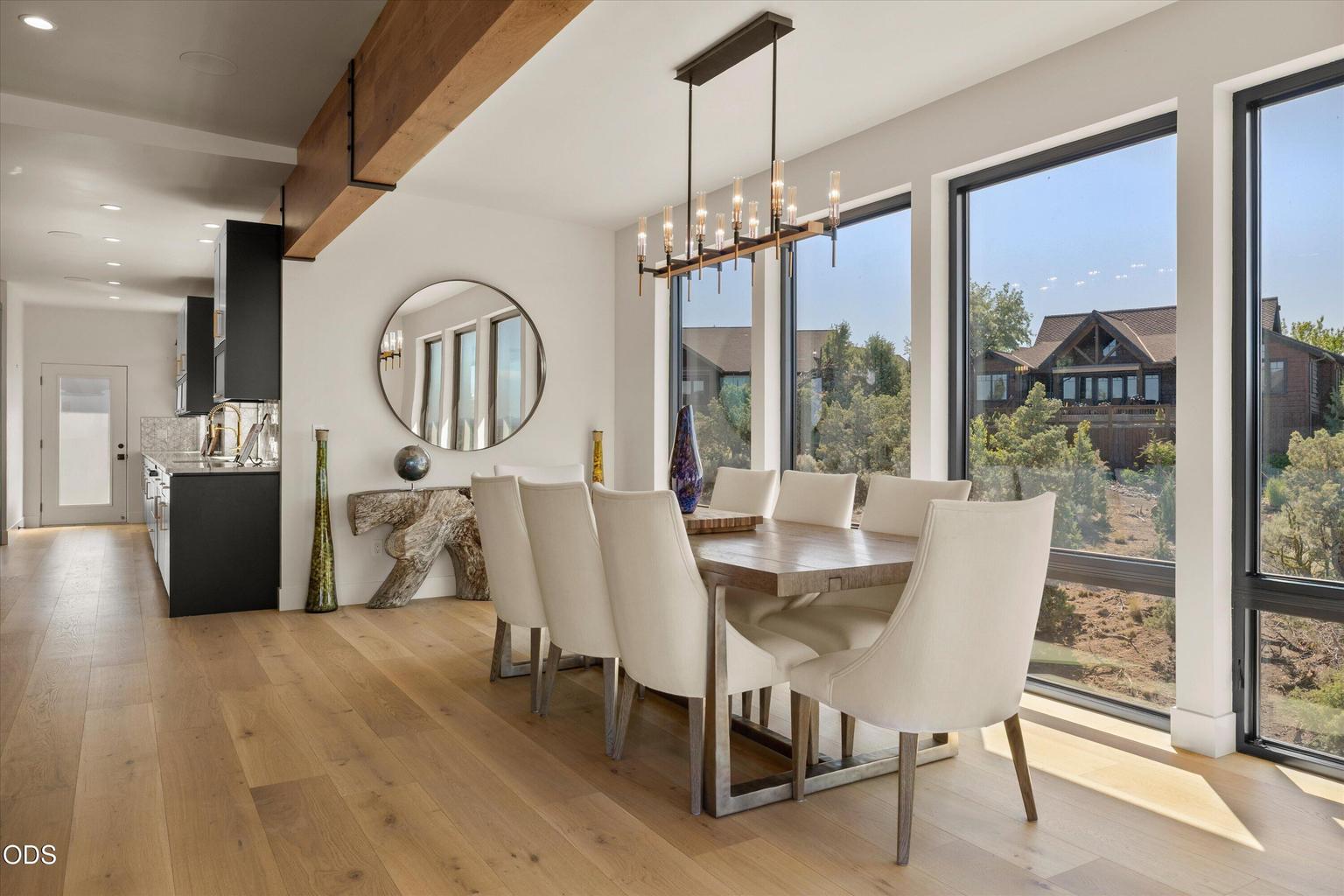 Dining framed by more oversized windows